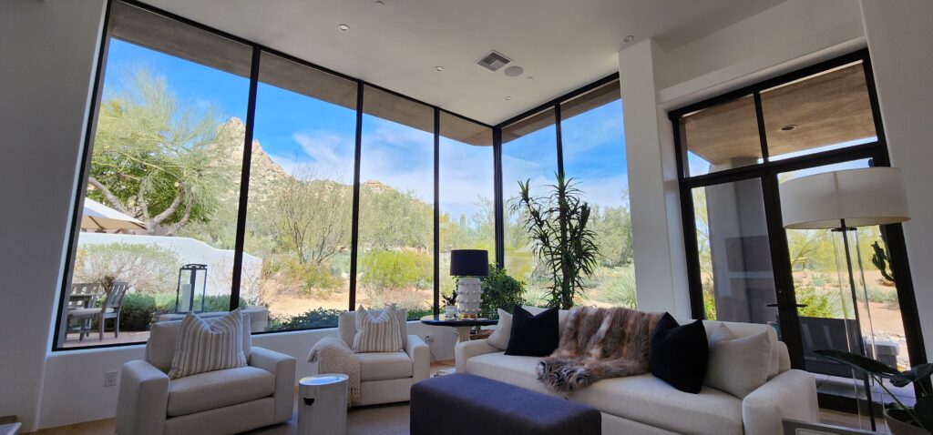 Living room with floor-to-ceiling windows and desert mountain views