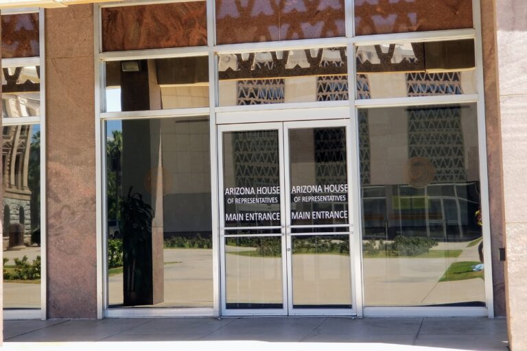 Government building entrance with film lettering on glass