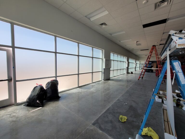 Long run of tall windows with film during installation