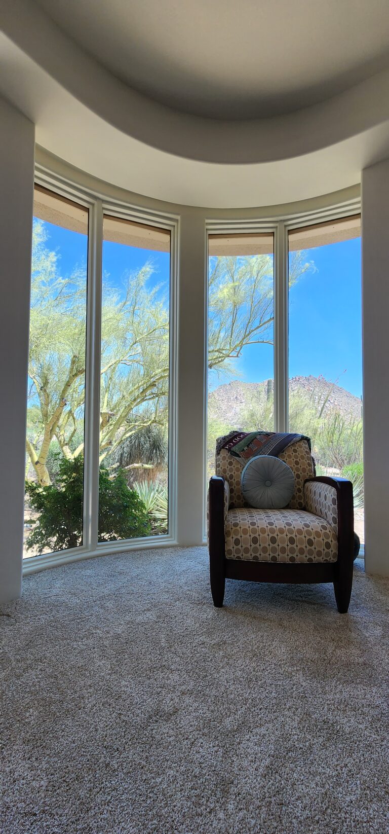 Curved window with a desert view and window film