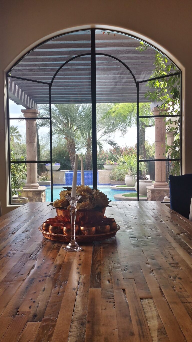 Arched windows with heat-blocking film overlooking a pool