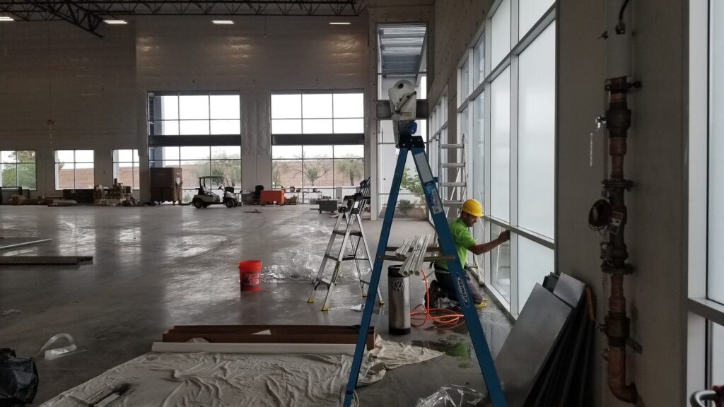 Installer applying window film in a large commercial space