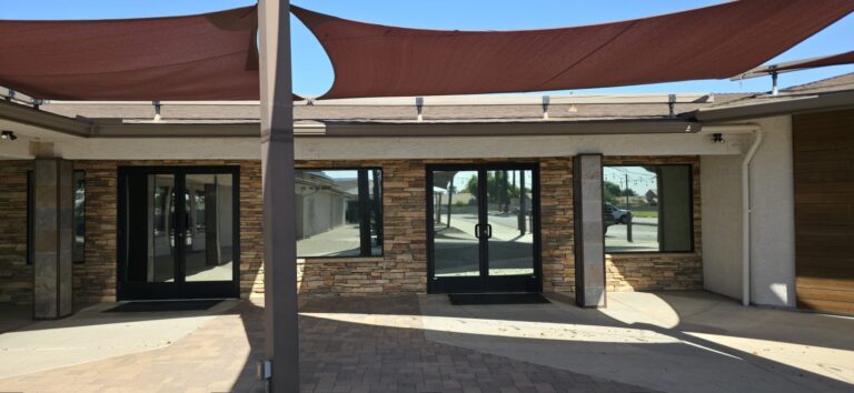 Courtyard entry with shade sails and tinted doors