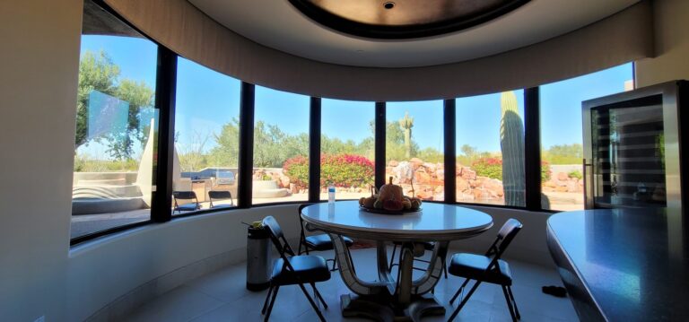 Round dining nook with tinted windows and a desert view
