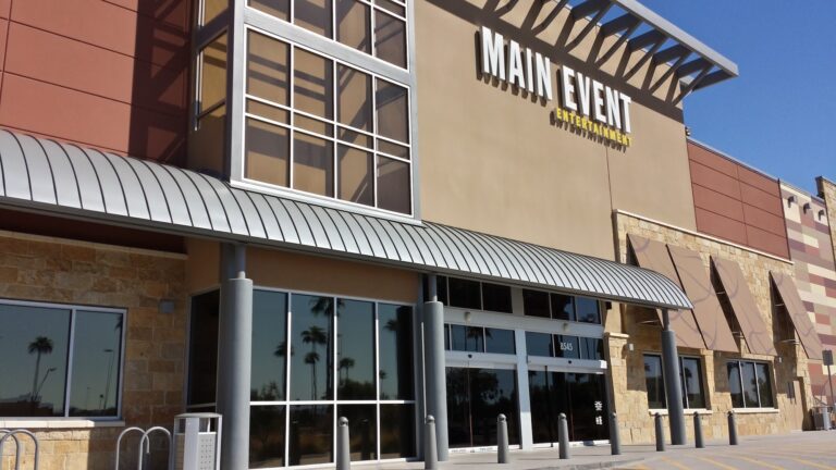 Entertainment venue entrance with tinted upper and storefront windows