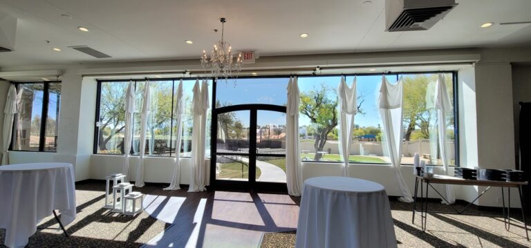Event venue with tall tinted windows and arched doors