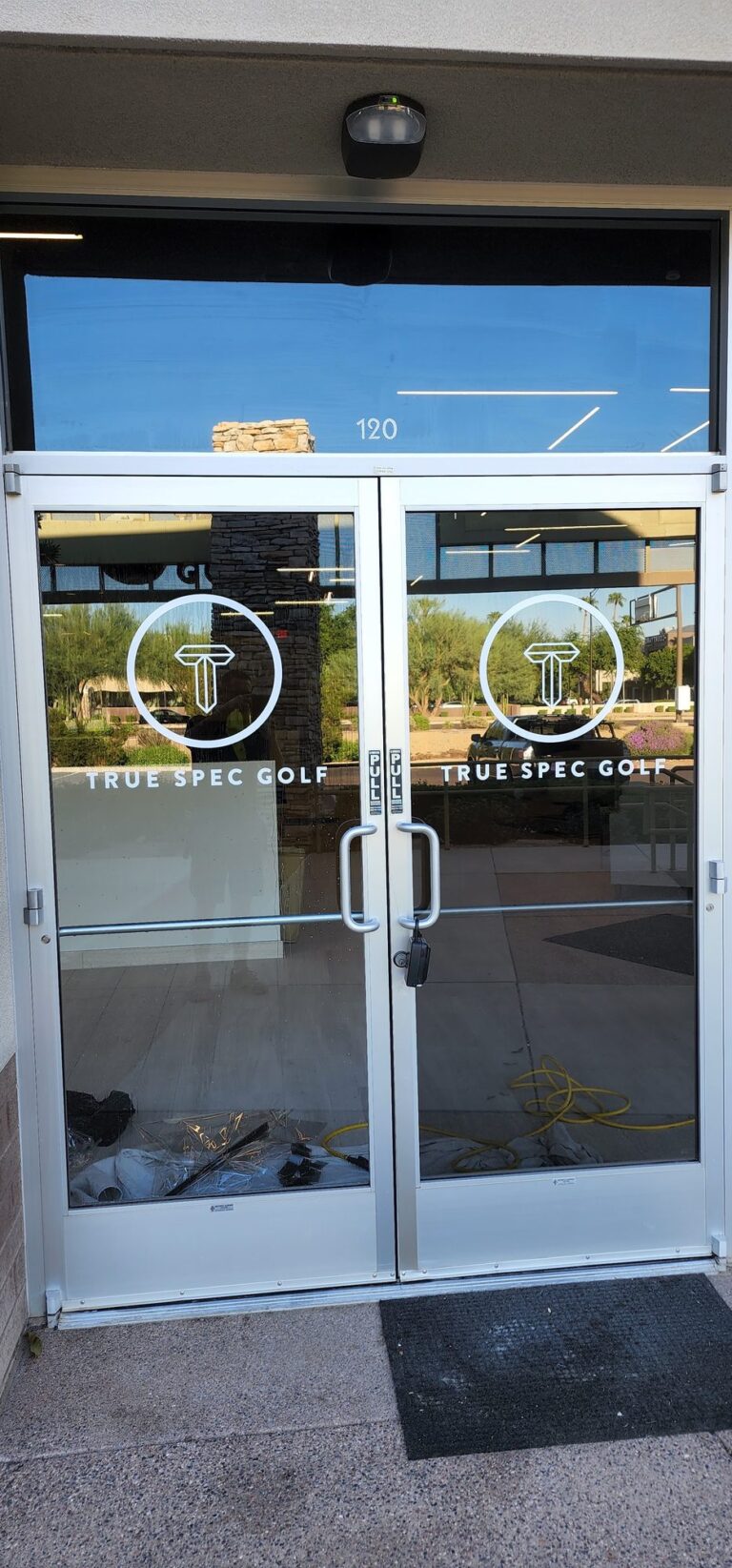 Glass entry doors with frosted logo graphics