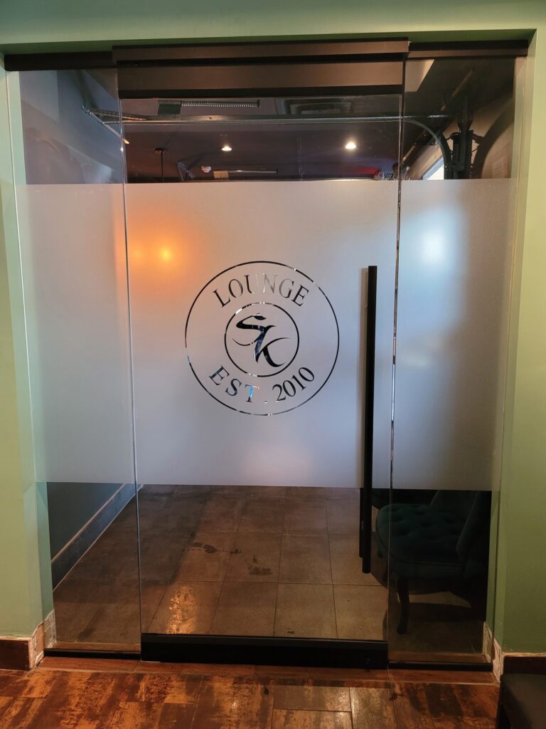 Lounge glass door with a frosted circular logo