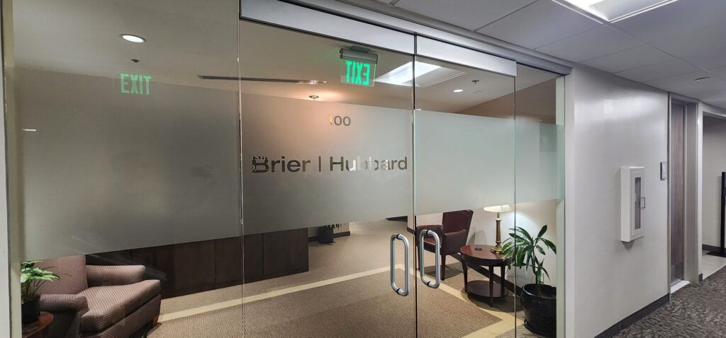 Office entry glass with a frosted company logo