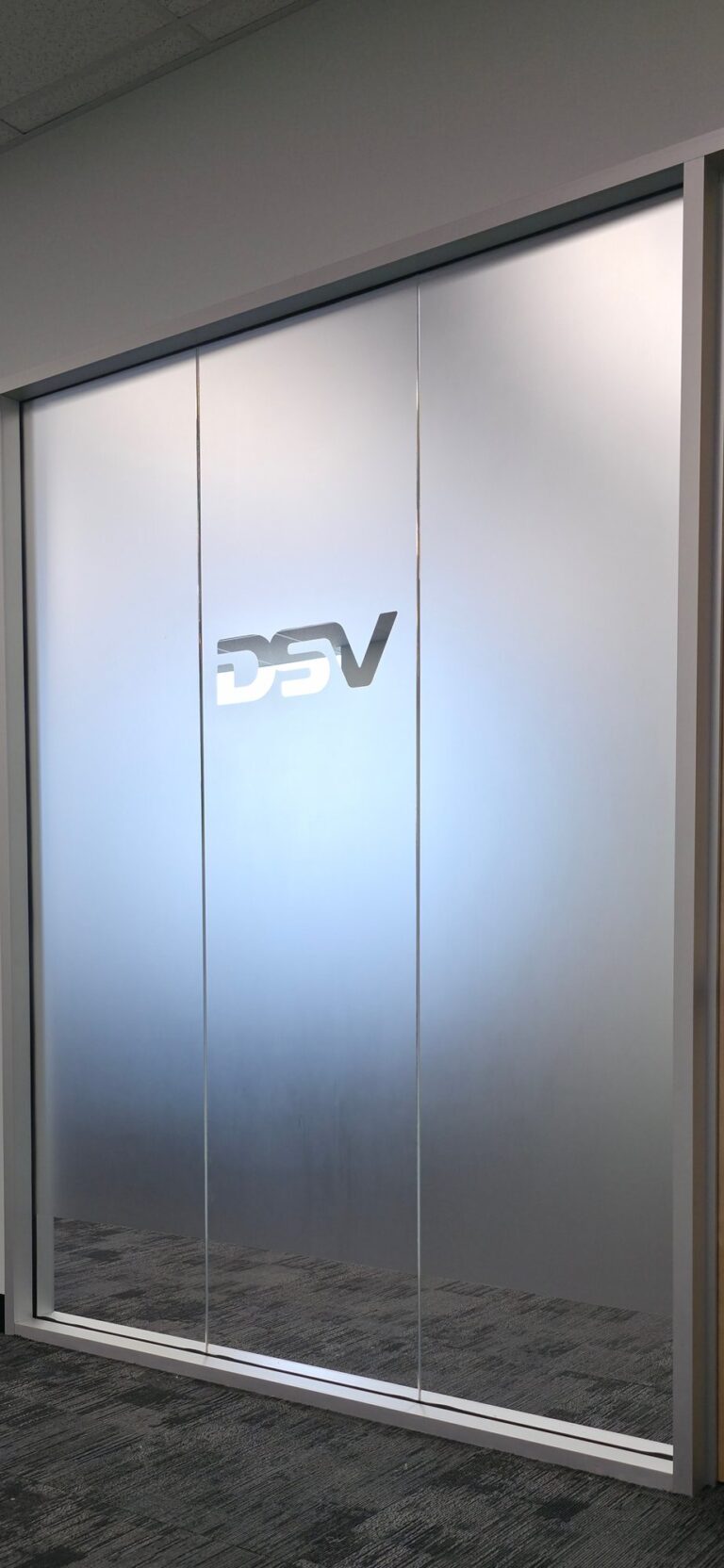 Frosted privacy film with a logo on an office glass door