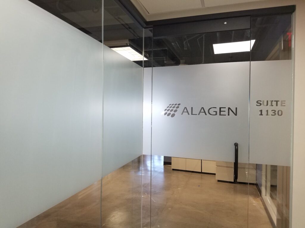 Frosted privacy film with a company logo on an office suite