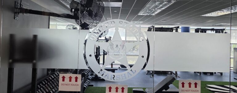 Glass wall with a large frosted seal graphic
