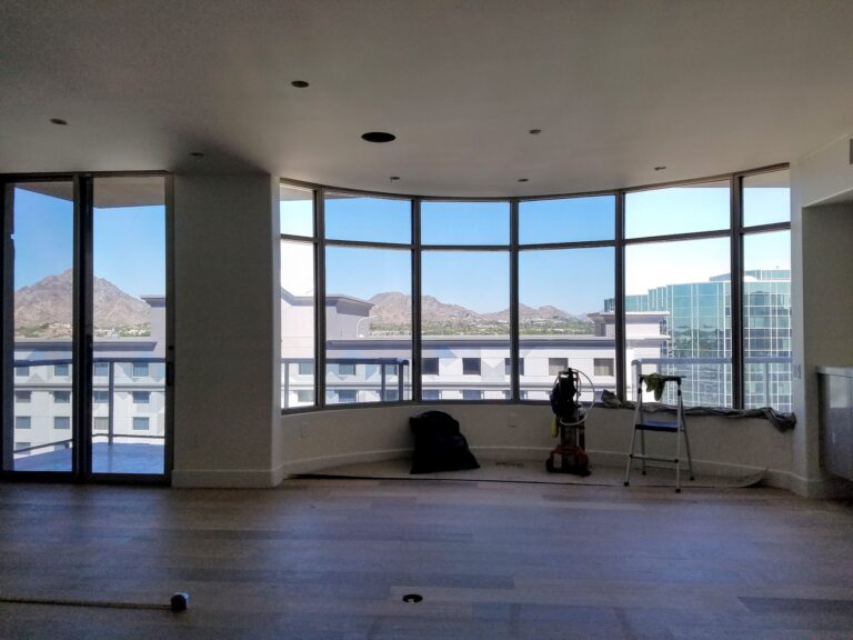 High-rise suite with curved windows, film installed, and mountain views