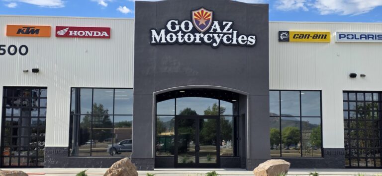Dealership storefront with tinted windows and arched entry